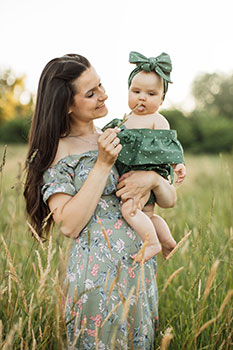 Mom holding her adorable infant daughter in her arms