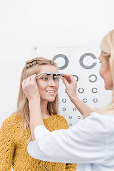 Woman getting an eye exam that's covered at no cost by her vision insurance